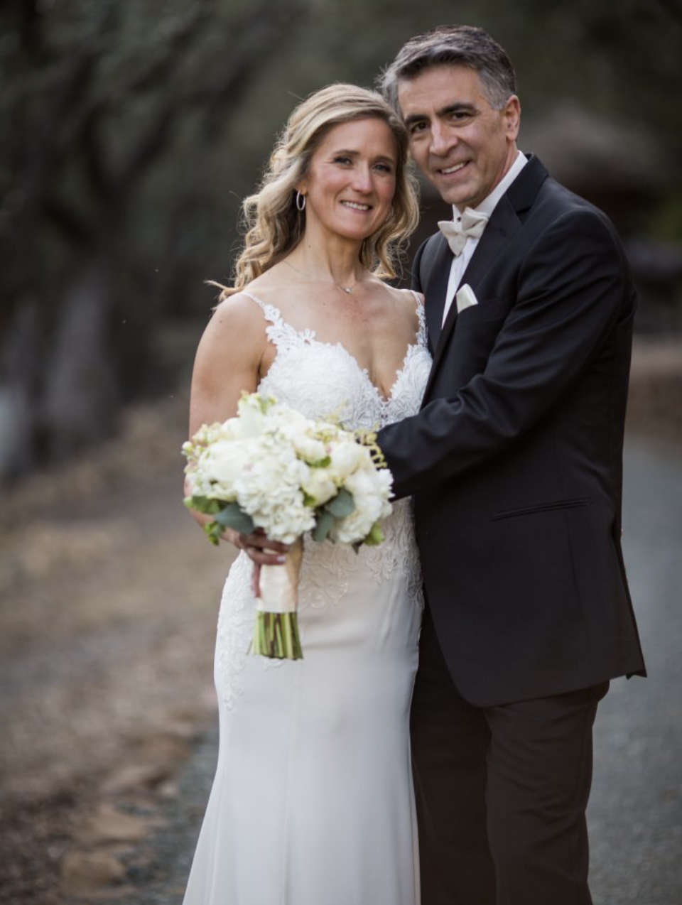 Сouple wearing a white gown and a black suit