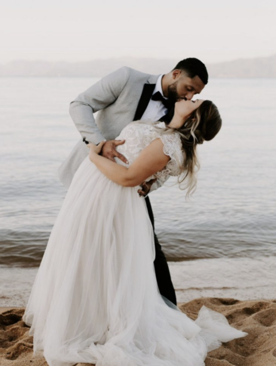 Сouple wearing a white gown and a gray suit